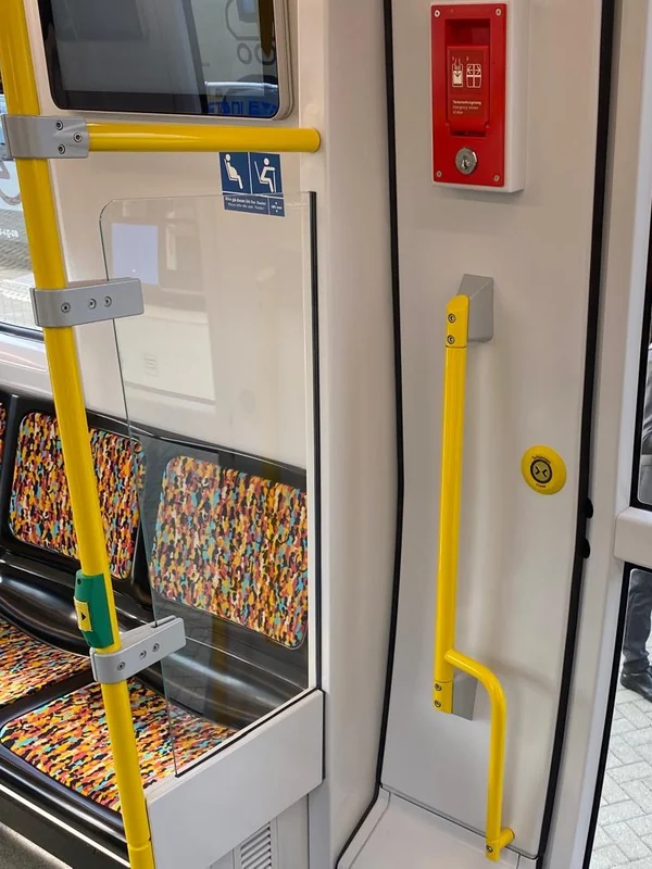 Door area with glass partition, grab poles and emergency control