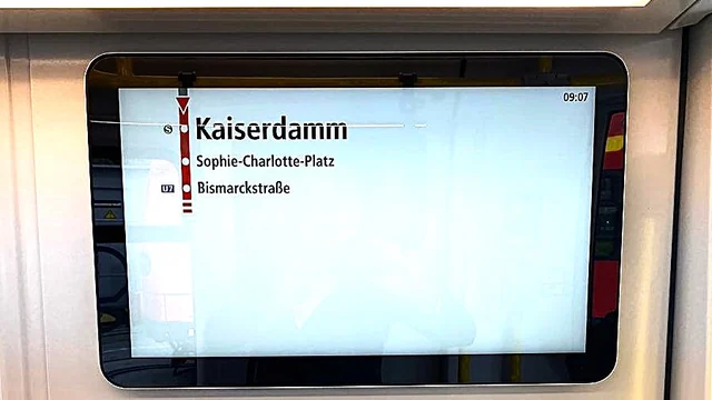 Wall-mounted passenger information screen inside the carriage