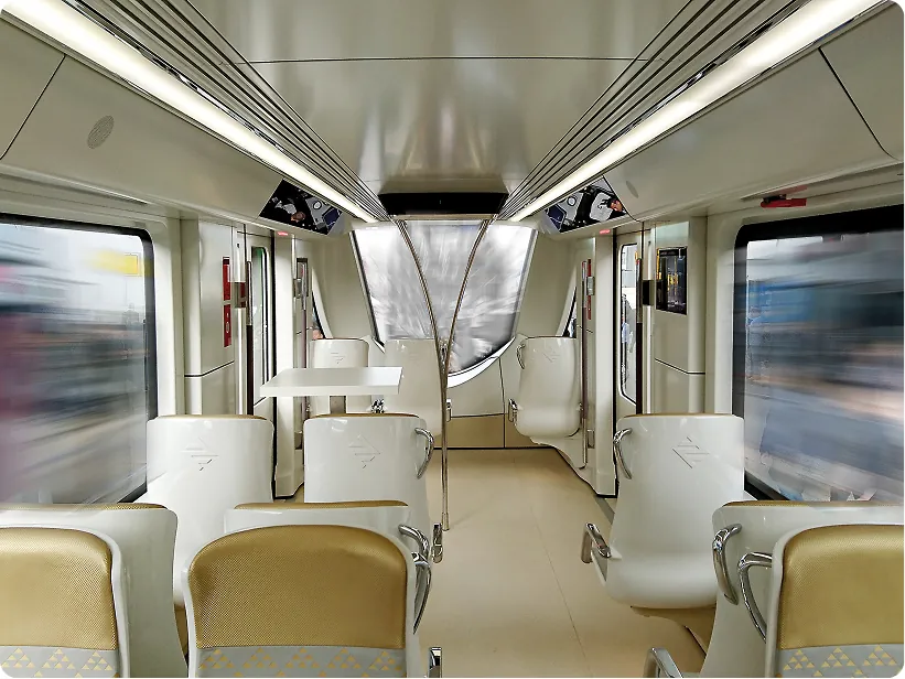 Carriage interior with white seat shells and a central table