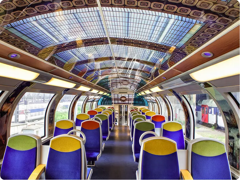 Carriage interior with a decorated stained-glass ceiling and coloured seats