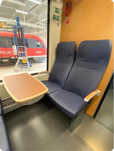 Pair of blue seats with a folding table by the window